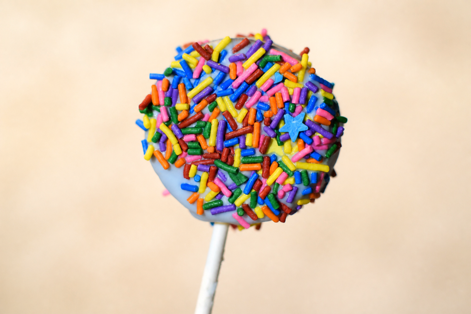 Real blue cake pop made by Yared and covered with colorful sprinkles