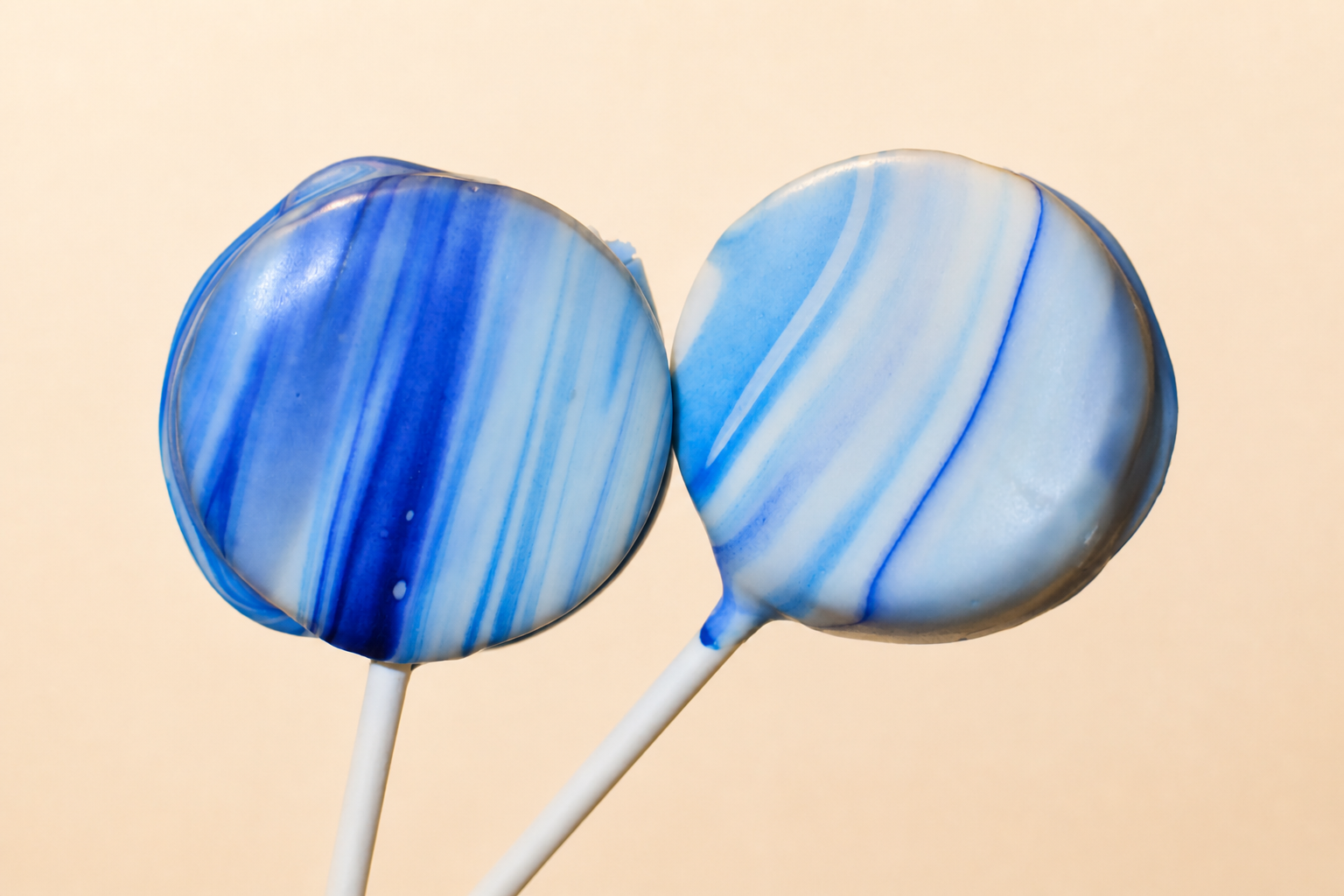 Two real blue and white marbled cake pops made by Yared